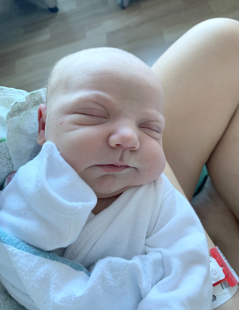 Teagan holds her baby boy in the hospital.