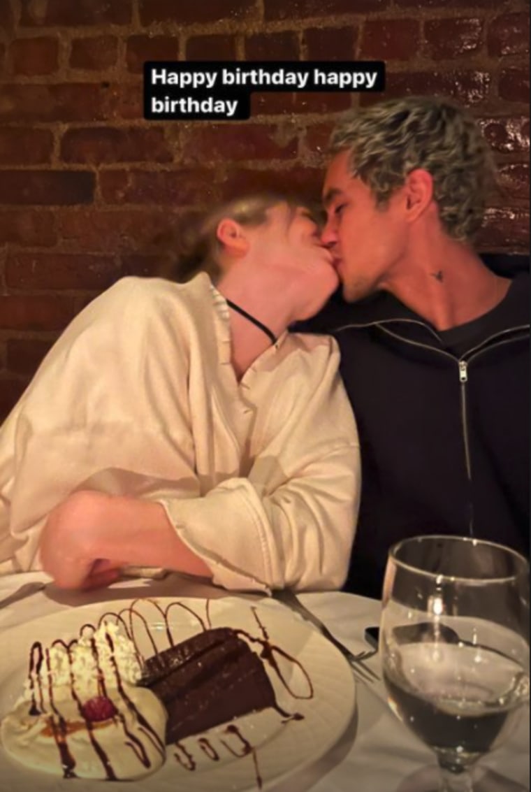 Schafer and Fike share a kiss over dinner.