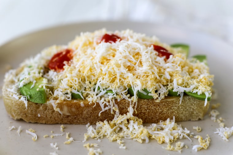 Thomas-Drawbaugh's avocado toast piled high with grated hard-boiled egg.