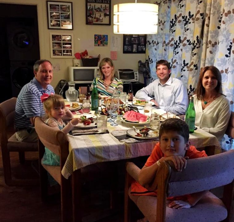 Clockwise from top left: Ken Paxton, Amber Briggle, Adam Briggle and Angela Paxton with Briggle's children in the front. The families gathered at Briggle's home to discuss LGBTQ+ rights over dinner.