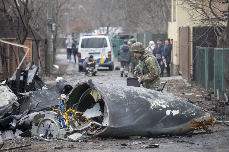 A Ukrainian Army soldier inspects fragments of a downed aircraft