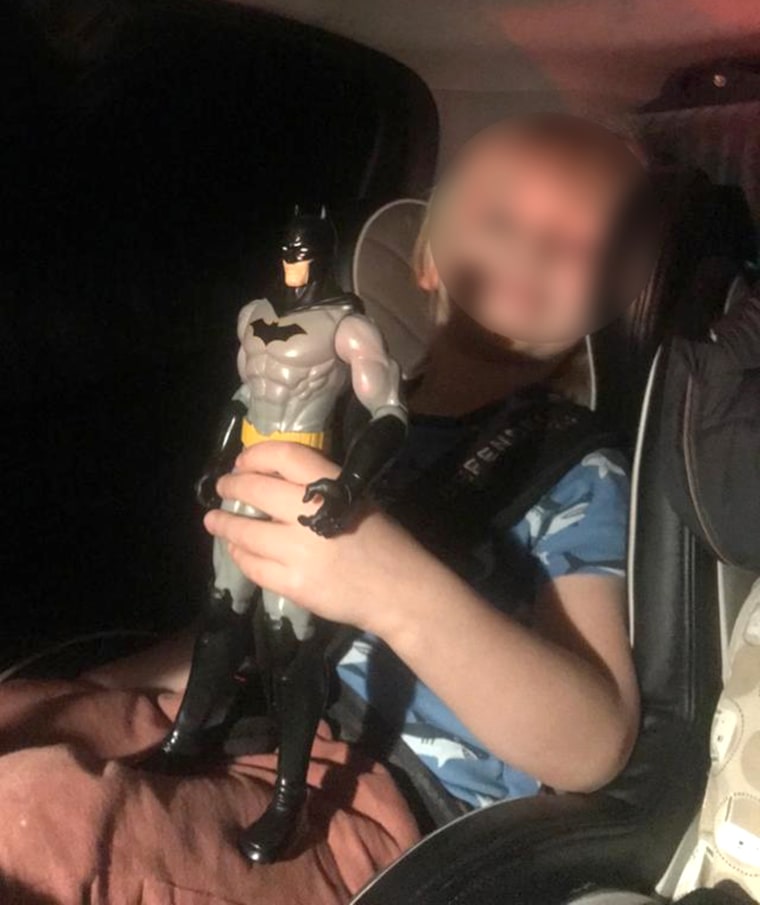 A picture of Dr. Y's 5-year-old son, fleeing Kyiv, Ukraine and holding his favorite Batman toy "to be brave." His face has been blurred to protect his safety and the safety of his family.