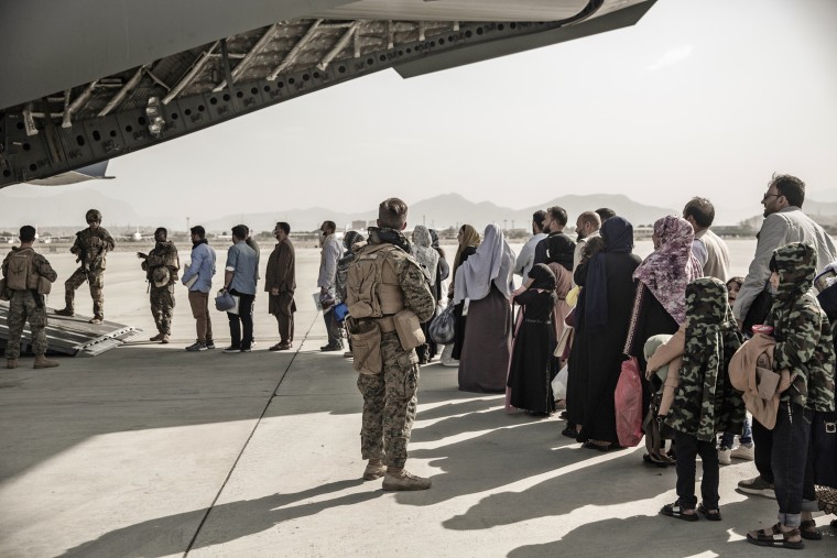 Evacuees wait to board a Boeing C-17 Globemaster III at Hamid Karzai International Airport in Kabul, Afghanistan, on Aug. 30.