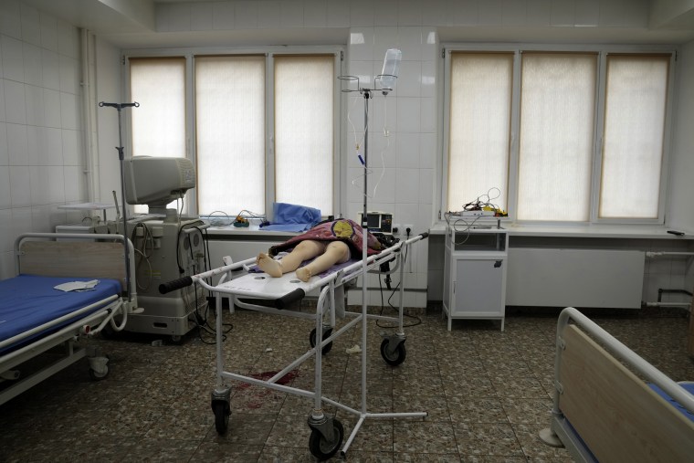 The lifeless body of a girl killed during the shelling of a residential area lies on a medical cart at the city hospital of Mariupol, eastern Ukraine, on Sunday.