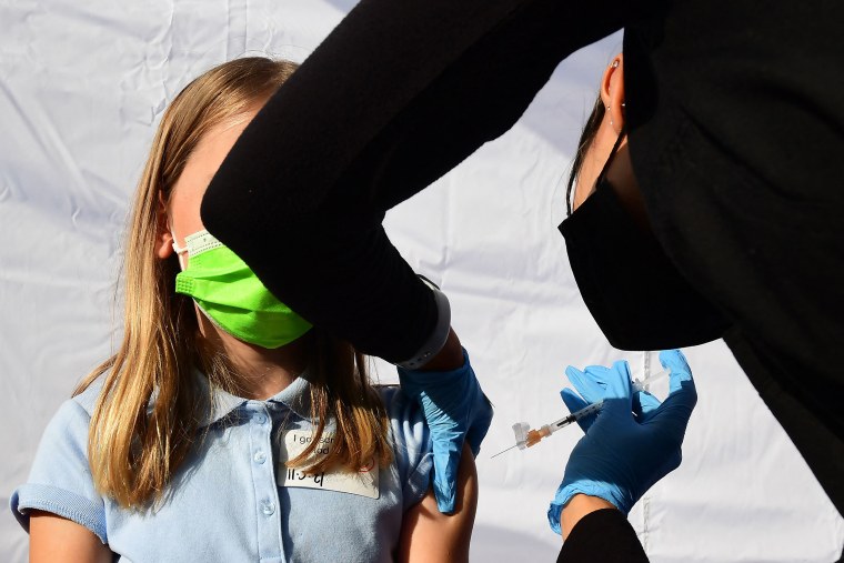 Image: A child receives a dose of Pfizer's Covid-19 vaccine in Los Angeles on Nov. 5, 2021.