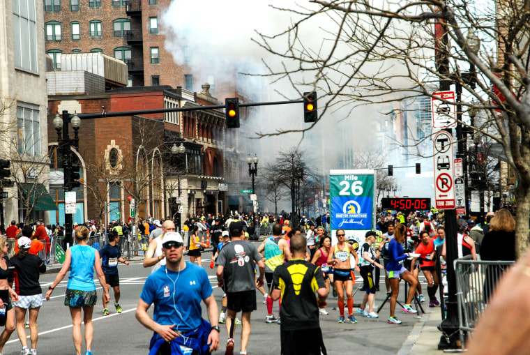 People running away from a blast during the Boston Marathon, in Boston, on April 15, 2013.
