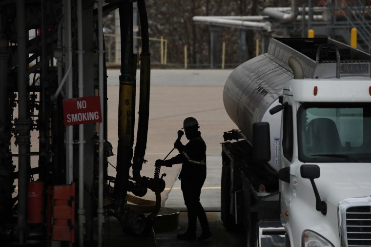 Image: A worker refuels a gasoline tanker truck at the Valero Energy Corp. oil refinery terminal in Memphis, Tenn. on Feb. 16, 2022.