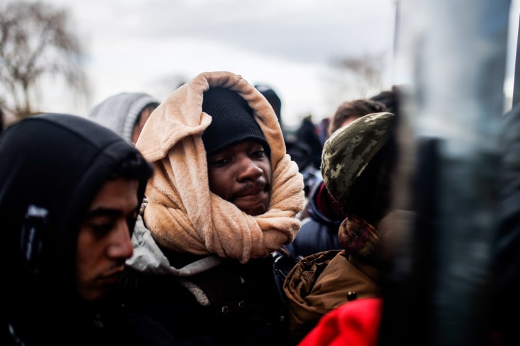 People wait for the bus to leave the border area at the Medyka border crossing on Feb. 28, 2022, in Medyka, Poland.