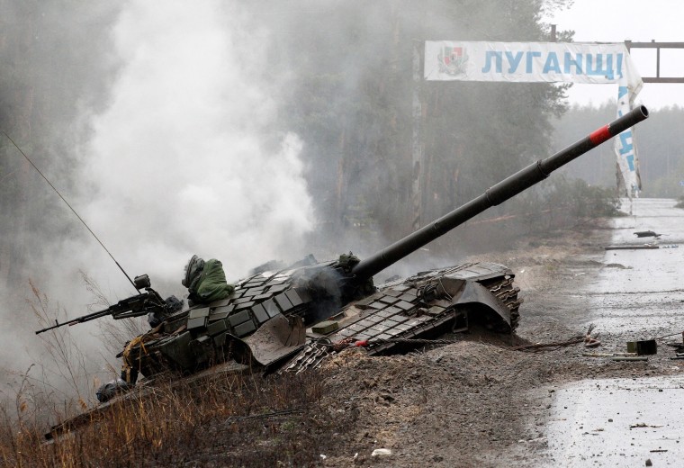 Image: Smoke rises from a Russian tank destroyed by the Ukrainian forces on the side of a road in Lugansk region on Feb. 26, 2022.