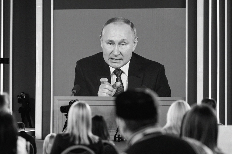 Attendees watch Russian President Vladimir Putin speak in Moscow on Dec. 23, 2021.