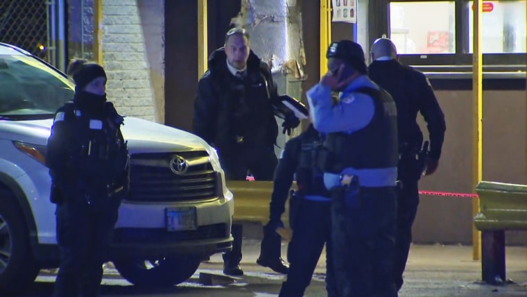 Two Chicago police officers were shot and wounded early Friday by a gunman who dropped a handgun while waiting in line at a restaurant with one of the officers, picked it up and opened fire, police said.