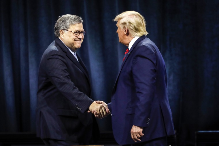 President Donald Trump shakes hands with Attorney General William Barr on Oct. 28, 2019, in Chicago.