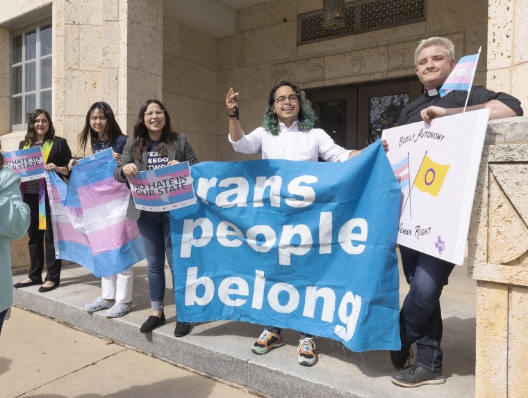 Adri Perez and others stand outside the Travis County courthouse