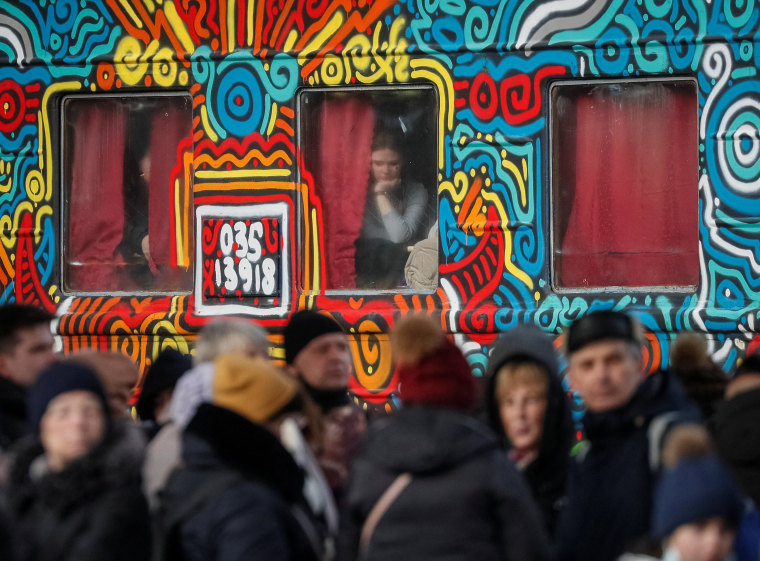 Image: People wait to board an evacuation train at Kyiv central train station