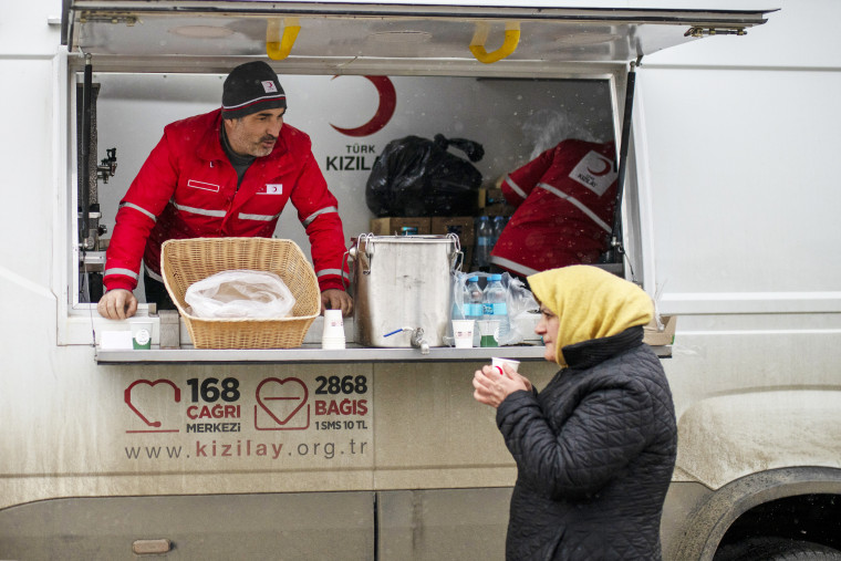 A woman receives a hot drink from the Turkish Red Cross at the Porubne border crossing  in western Ukraine on Mar. 5, 2022.