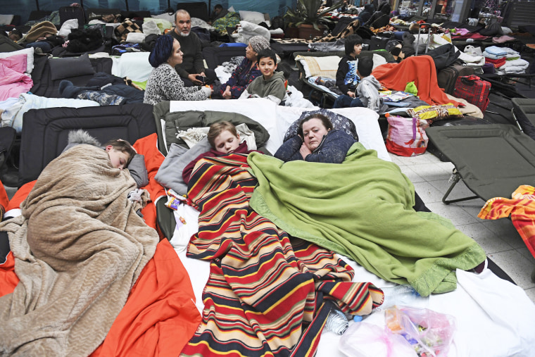 People sleep on cots at a reception center for displaced persons from Ukraine at the Ukrainian-Polish border crossing in Korczowa, Poland on Mar. 5, 2022.