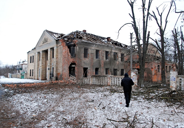 A man walks in front of a building damaged by recent shelling in Kharkiv, Ukraine, on March 6, 2022.