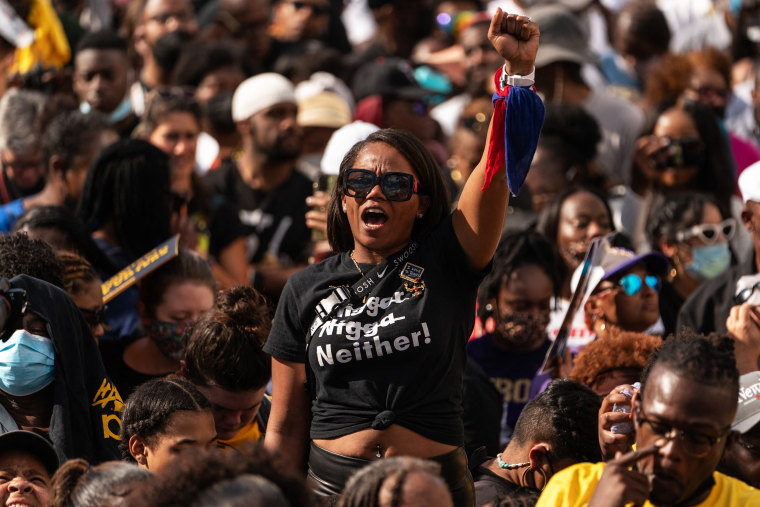 A woman raises her fist in the air prior to the arrival of Vice President Kamala Harris at the 57th anniversary of "Bloody Sunday" in Selma, Ala. on Sunday, March 6.