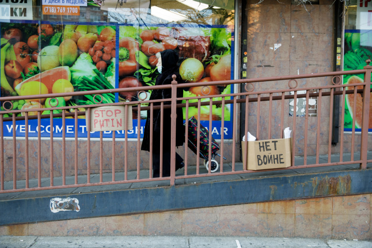 Signs reading "Stop Putin" in English and "No War" in Russian adorn a railing outside Brighton Bazaar in the Brighton Beach neighborhood of Brooklyn, N.Y., on March 4, 2022.