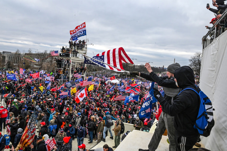 Trump supporters clash with police and security forces as they invade the Inauguration platform of the U.S. Capitol in Washington, DC on Jan. 6, 2021.