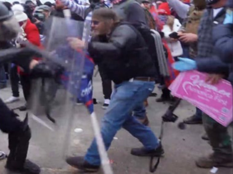 Image: Ralph Joseph Celentano with a folding chair on his back.