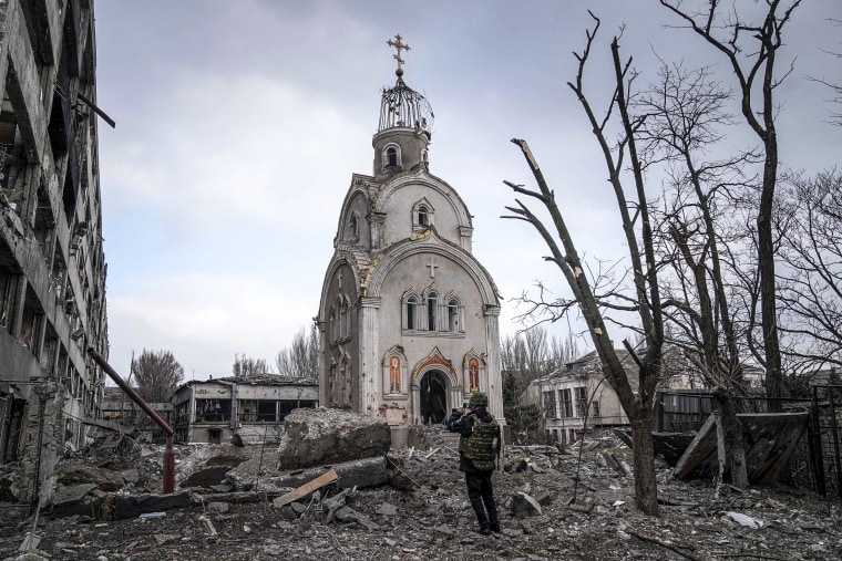 Image: A Ukrainian serviceman takes a photograph of a damaged church after shelling in a residential district in Mariupol, Ukraine on March 10, 2022.