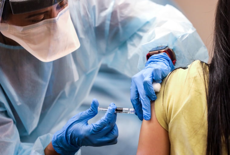 A nurse administers a flu vaccination at a free clinic held at a local library on Oct. 14, 2020, in Lakewood, Calif.
