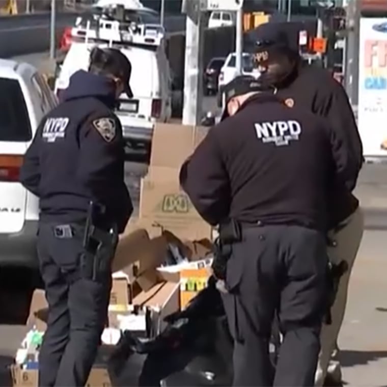 New York police crime scene officers investigate the scene where the remains of a 68-year-old woman were found in Brooklyn, N.Y.