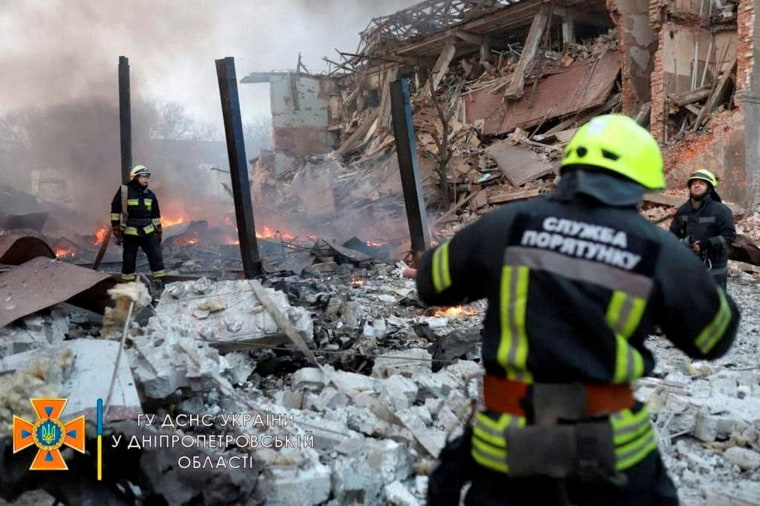Image: Rescuer works among remains of buildings damaged by airstrike in Dnipro