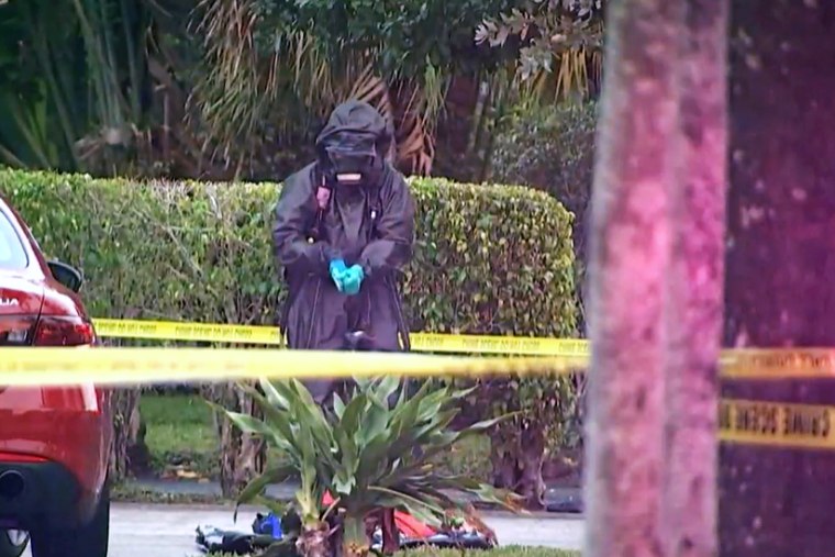 An investigator in a hazard suit stands outside the Spring Break home of West Point cadets who overdosed on cocaine laced with fentanyl, according to reports, in Ft Lauderdale, Fla., on Friday.