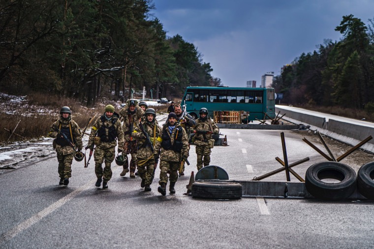 Soldiers arrive to reinforce one of the final checkpoints before the frontlines where Ukrainian forces are battling invading Russian forces near Brovary, Ukraine, on March 8, 2022.