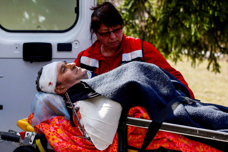 A medic transports a serviceman on a stretcher following an attack on the Yavoriv military base at a hospital in Yavoriv, Ukraine, on March 13, 2022.