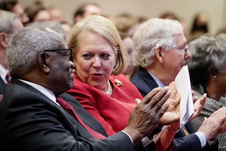 Associate Supreme Court Justice Clarence Thomas sits with his wife and conservative activist Virginia "Ginni" Thomas October 21, 2021 in Washington, DC.