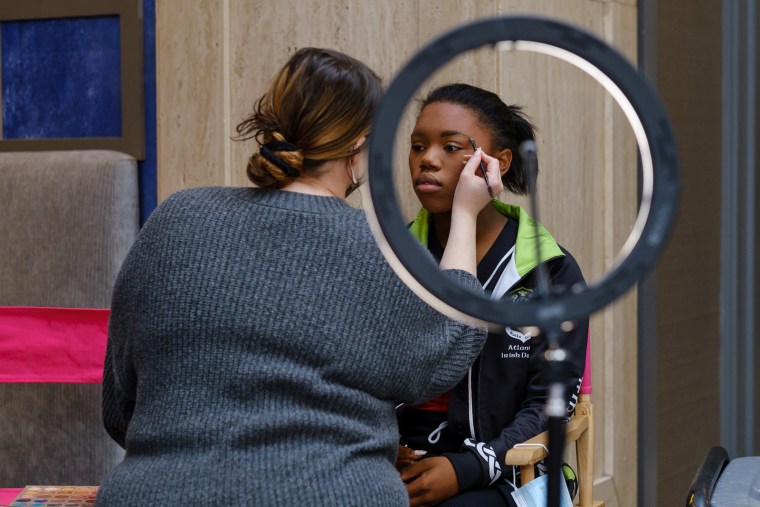 Imani Johnson has her makeup done at a competition.