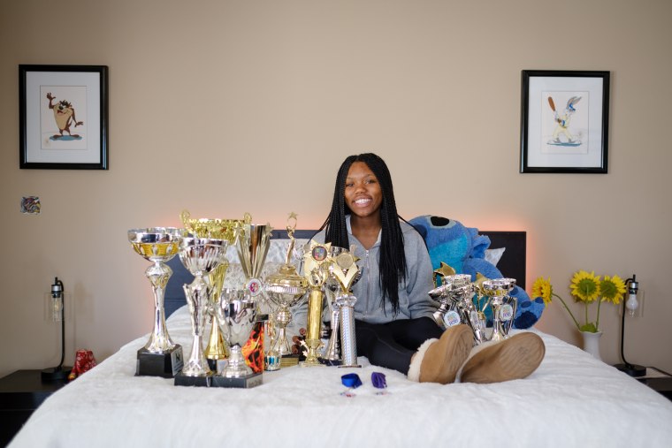 Imani Johnson poses with some of her trophies.