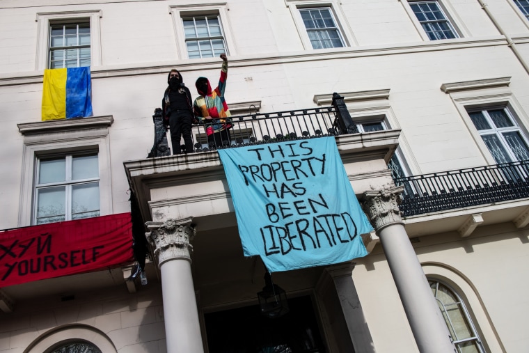 Protesters occupy a building reported to belong to Russian oligarch Oleg Deripaska on March 14, 2022, in London.
