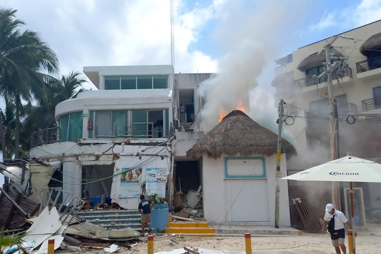 People stand outside the Kool Beach Club after a gas tank explosion in Playa Del Carmen, Mexico, on March 14, 2022.