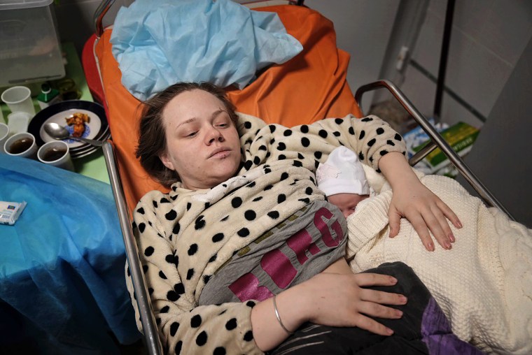Mariana Vishegirskaya lies in a hospital bed after giving birth to her daughter Veronika in Mariupol.
