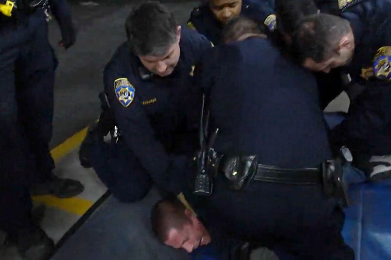 Edward Bronstein is held down by CHP officers.