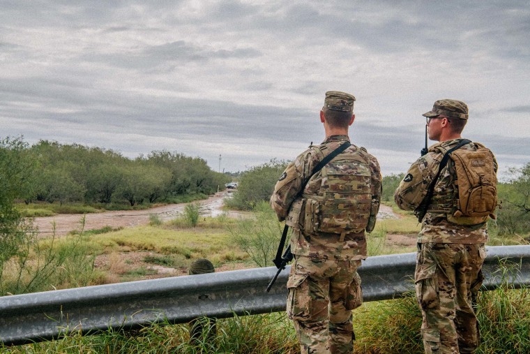 U.S. National Guard members patrol near an unfinished section of border wall on November 18, 2021 in La Joya, Texas.