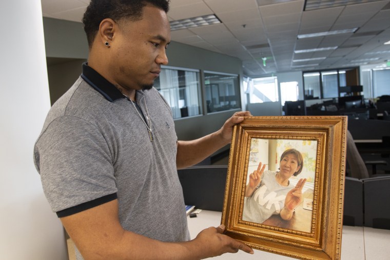 Robert Peterson holds a photo of his late mother, Yong Ae Yue, one of the eight victims of the Atlanta-area spa shootings.