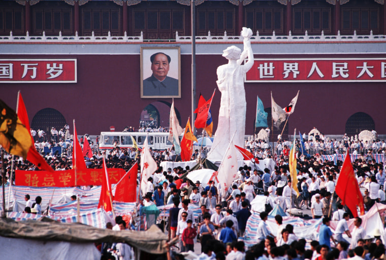 The "Goddess of Democracy" stands tall amid a huge crowd of