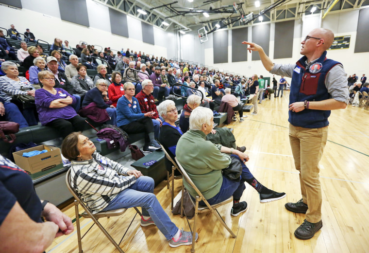 Christopher Le Mon, right, a precinct captain for then-presidential candidate Joe Biden, counts supporters during the Democratic caucus at Hempstead High School in Dubuque, Iowa, on Feb. 3, 2020.