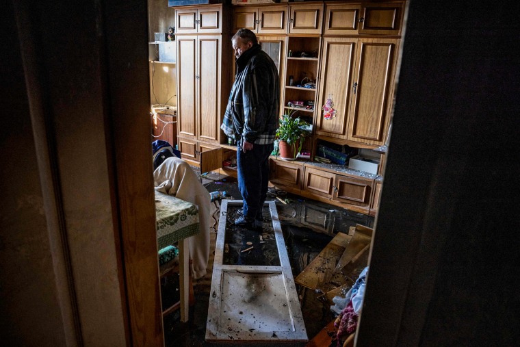 A resident stands in his apartment damaged by shelling in Kyiv on March 15, 2022.