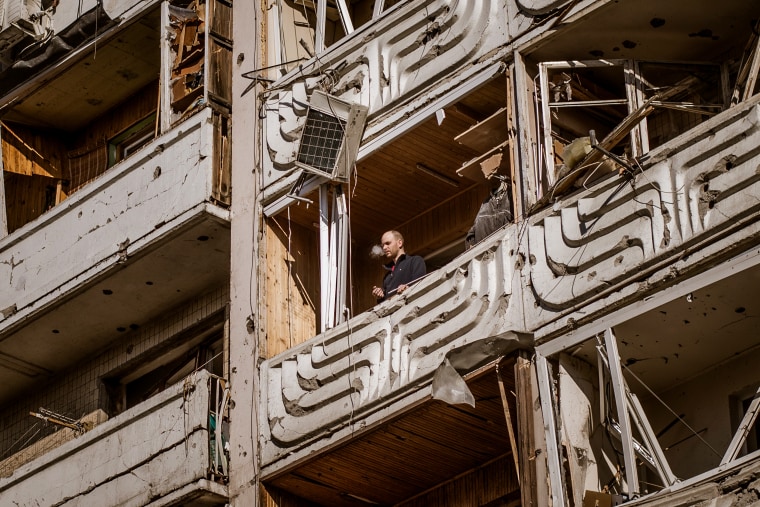A man stands on the balcony of a destroyed residential building in Kyiv, Ukraine, on March 15, 2022.