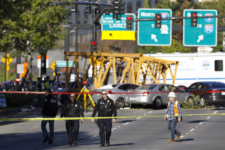 Emergency crews work at the scene of a construction crane collapse