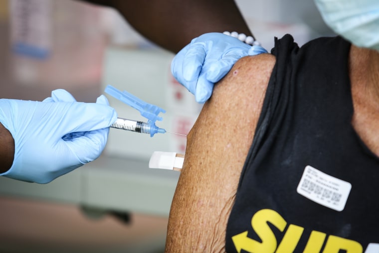 A health worker administers a Covid-19 vaccination dose during a vaccination clinic for homeless people in downtown Miami on May 13, 2021.