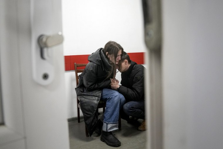 Marina Yatsko and her boyfriend Fedor comfort each other after her 18-month-old son Kirill was killed in shelling.