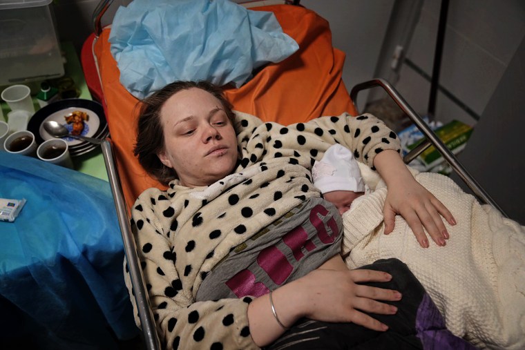 Mariana Vishegirskaya lies in a hospital bed after giving birth to her daughter Veronika. 