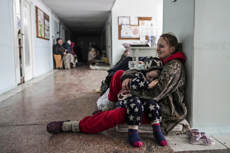 Anastasia Erashova cries as she hugs her child in a corridor of a hospital in Mariupol, Ukraine. on March 11, 2022. Anastasia's other child was killed during shelling in Mariupol.